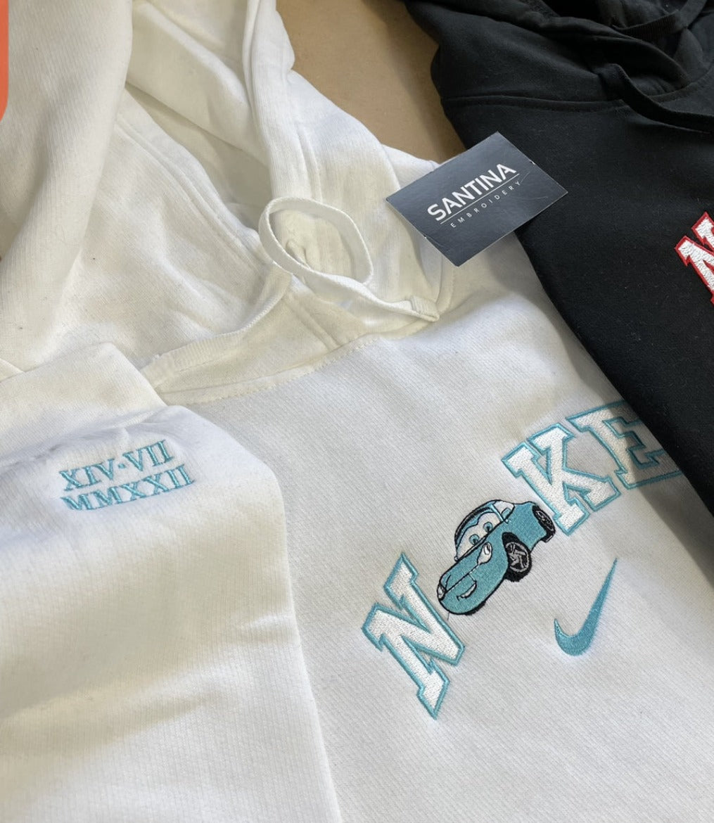A stylish white hoodie with an embroidered car design.