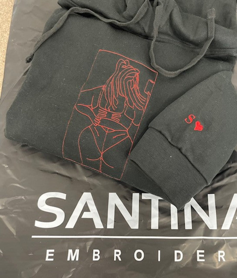 Black hoodie with fiery red embroidered design.