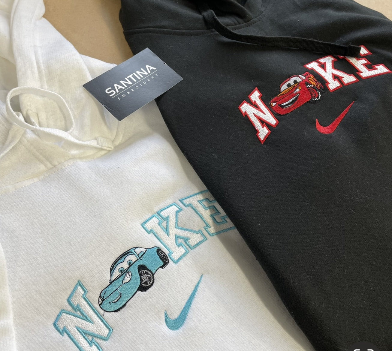A black hoodie with an adorable car embroidery.