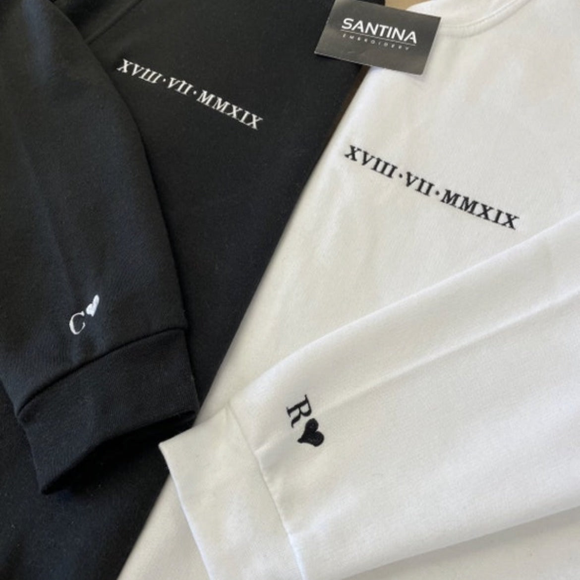 Custom embroidered Roman numeral sweatshirt with monogrammed initials on the sleeves.