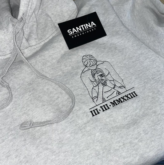 Custom embroidered hoodie featuring a portrait outline of a happy family