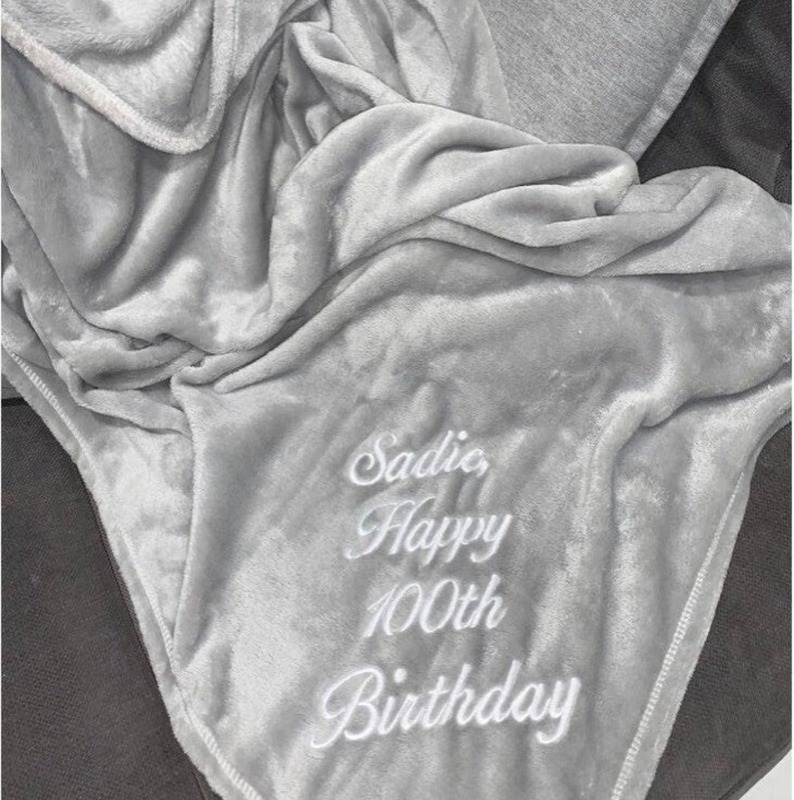 A cozy personalized blanket embroidered with your unique message